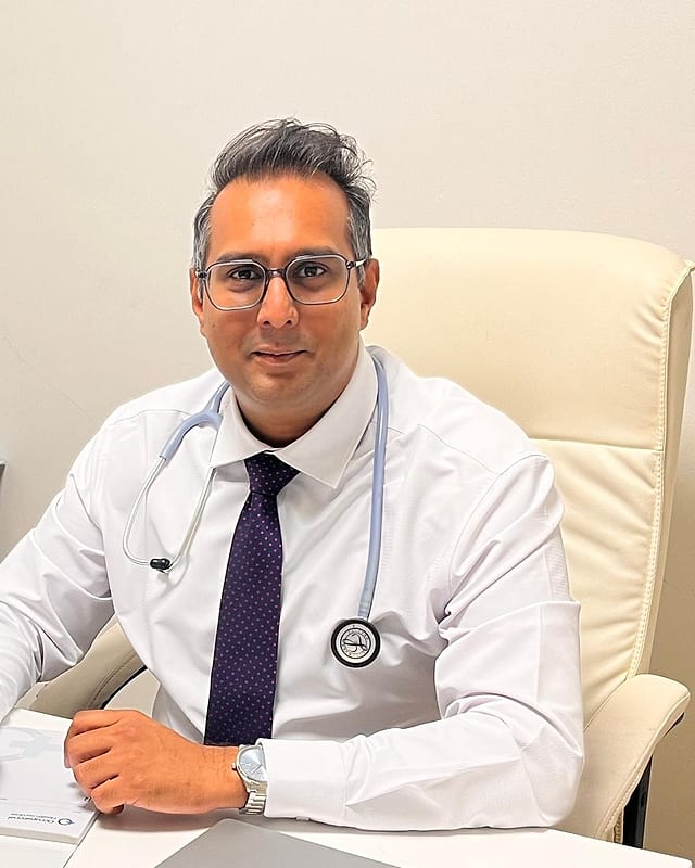 Dr Shahil Dawreeawoo, Occupational Health Physician, at his consulting room desk
